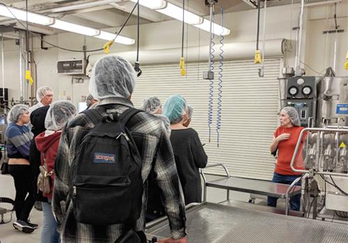 Instructor teaching students about food safety in a food facility